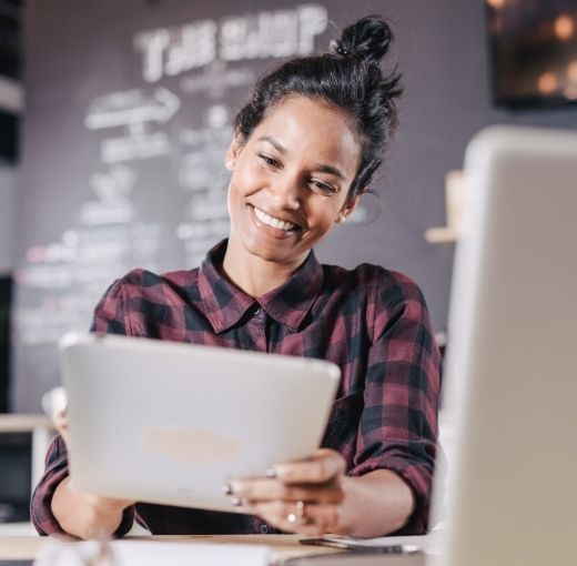 Smiling woman looking at the screen of her tablet